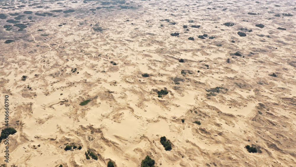 Aerial View of the Textures and Patterns of the Desert Sands. Beautiful landscape . Desert and green bushes Aerial View of the Textures and Patterns of the Desert Sands. Beautiful landscape . Desert and green bushes