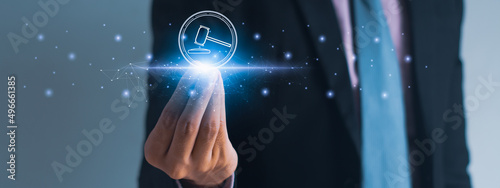 Businessman using hand holding hammer icon,futuristic line network, concept bid winner highest bidder in final lift,public sale property auctioned business competition,e-auction and online bidding photo
