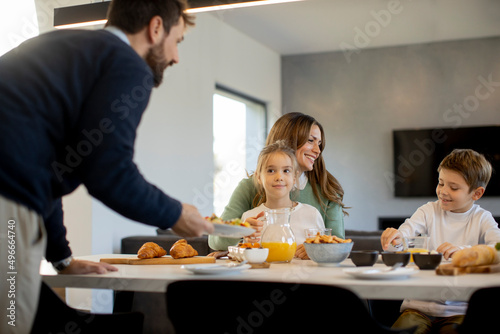 Young happy family talking ...