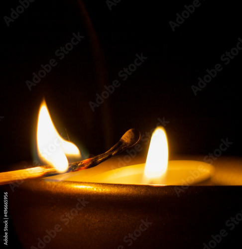 fire of a burning match on a black background. candle flame ignited matches