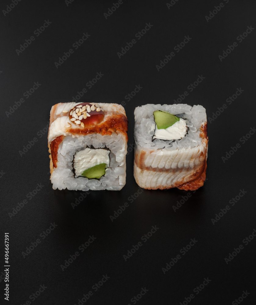 maki sushi with eel on black background closeup maki sushi with eel on black background closeup