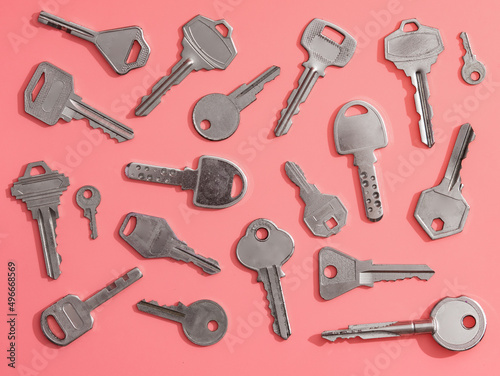 Collection of silver key on pink background