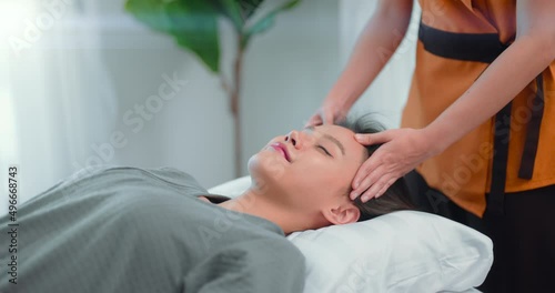 Beautiful woman having head massage in the spa.