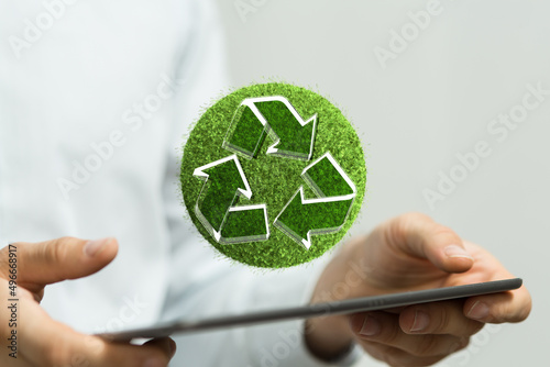 hand holding green recycle ...
