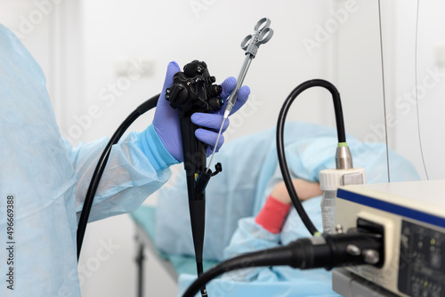 Endoscopic examination.
Instruments for gastroscopy and colonoscopy close-up. The doctor holds a flexible endoscope and biopsy forceps in his hands. Endoscopy and minimally invasive surgery. photo