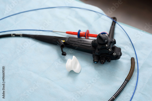 Endoscope, mouthpiece and biopsy forceps. Apparatus for gastroscopy, bronchoscopy, colonoscopy close-up. Tools for medical diagnostics close-up. Gastrointestinal endoscopy in the operating room. photo