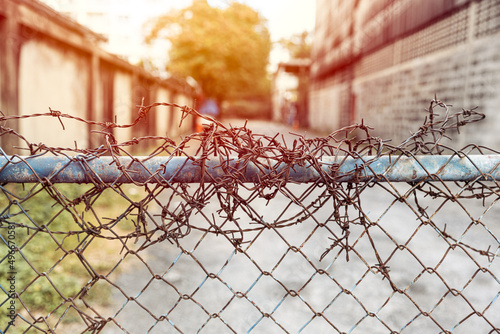 Barbed wire entrance fences prevent intruders from entering restricted areas. photo