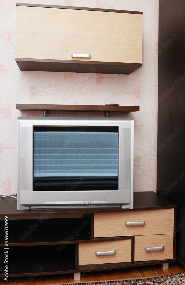 Old TV with noise and interference on the screen in the interior. Old TV with noise and interference on the screen in the interior.