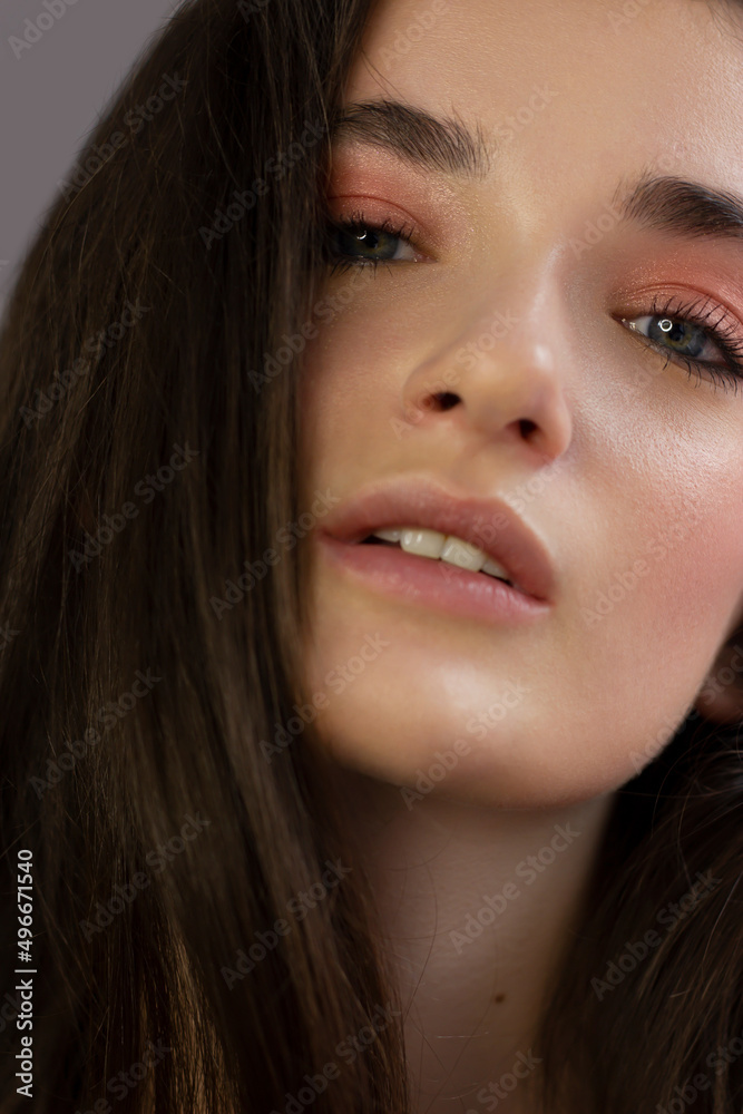 Close-up portrait of a beauty woman with full lips, straight hair and perfectly clean skin. Daytime makeup, styling and soft care. Skin care in the spa salon or cosmetology, smooth eyebrows Close-up portrait of a beauty woman with full lips, straight hair and perfectly clean skin. Daytime makeup, styling and soft care. Skin care in the spa salon or cosmetology, smooth eyebrows