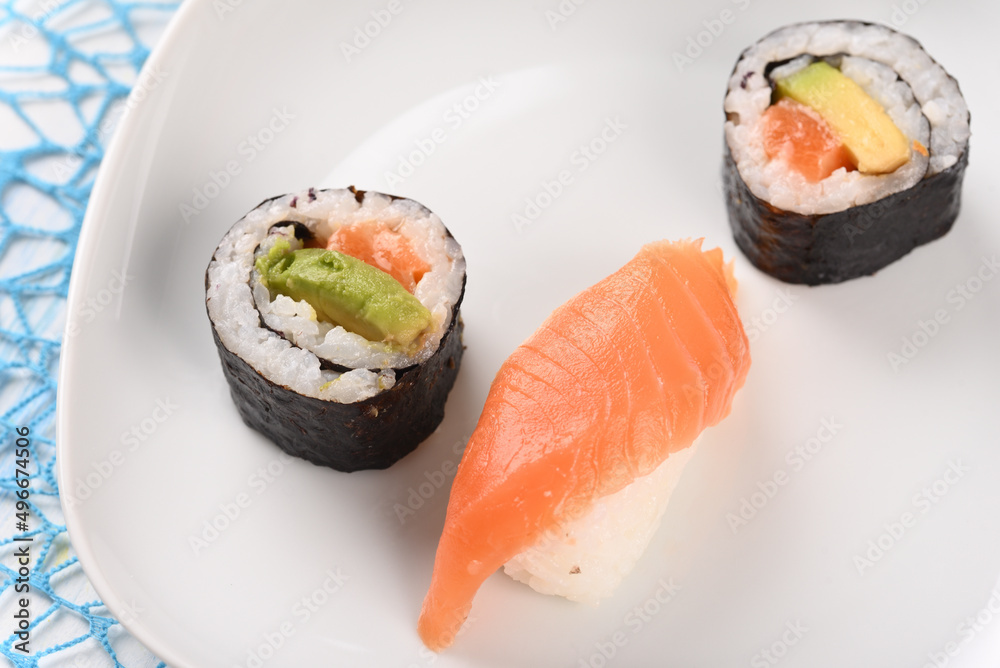 Sushi and rolls on a white plate. Sushi and rolls on a white plate.