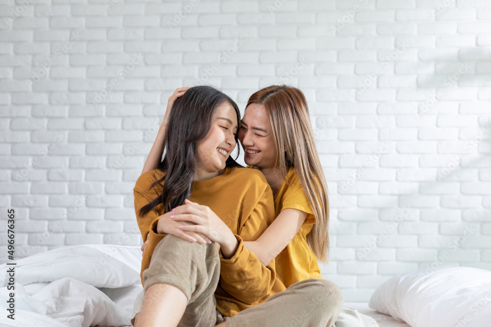 Beautiful two female LGBT lesbian embracing and looking together with love and romance on bed.Positive mood and moment of LGBTQ lesbian lying on white bed relax and comfort.LGBTQ Lifestyle Concept Beautiful two female LGBT lesbian embracing and looking together with love and romance on bed.Positive mood and moment of LGBTQ lesbian lying on white bed relax and comfort.LGBTQ Lifestyle Concept