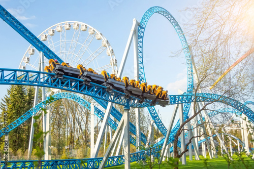 Slika na platnu Amusement trolley makes circle loop turns rides in a spiral, roller coaster