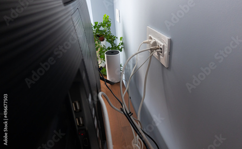 Obraz na płótnie Home related do it yourself activities. Cable management for the power outlet, internet and TV wires hidden behind the smart tv on a wooden console in a flat. w salonie