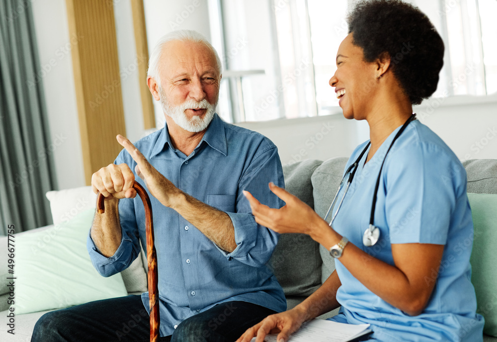 Obraz premium nurse doctor senior care caregiver help assistence retirement home nursing elderly woman man health support african american black walking cane