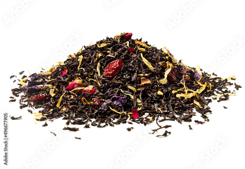Heap of Black tea with rose, cherry and pieces of cinnamon on white background. Close up. High resolution.