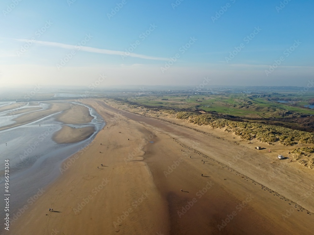 Aerial drone. Camber Sands in East Sussex. Popular seaside destination with large sandy beach and surfing spot in England. Aerial drone. Camber Sands in East Sussex. Popular seaside destination with large sandy beach and surfing spot in England.