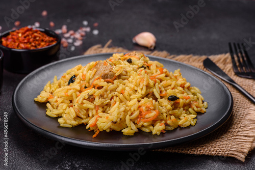 Pilaf or pilau with chicken, traditional uzbek hot dish of boiled rice, chicken meat, vegetables and spices