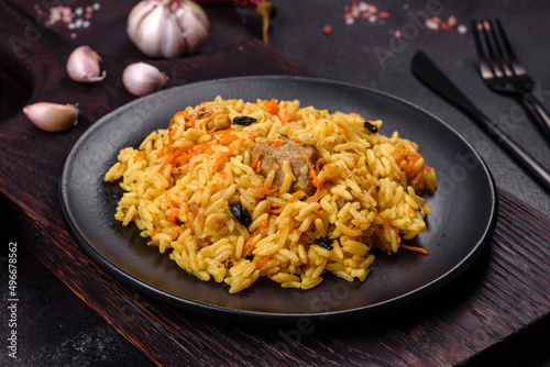 Pilaf or pilau with chicken, traditional uzbek hot dish of boiled rice, chicken meat, vegetables and spices
