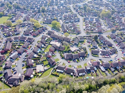 Aerial drone. Top down view of houses in England. New builds development. Typical British homes and green gardens. Real estate and buildings concept.