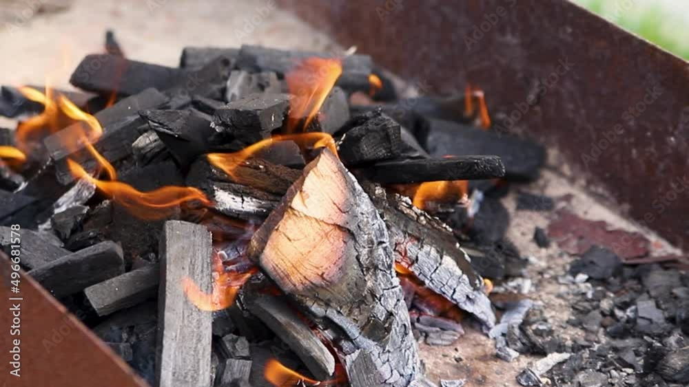 A brightly burning bonfire with a red flame made from wood in an outdoor grill.An adventurous lifestyle in travel. Active weekend recreation in the wild outdoors. A brightly burning bonfire with a red flame made from wood in an outdoor grill.An adventurous lifestyle in travel. Active weekend recreation in the wild outdoors.