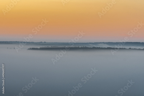 Foggy morning over the steppe and the river. Dawn in the fog.