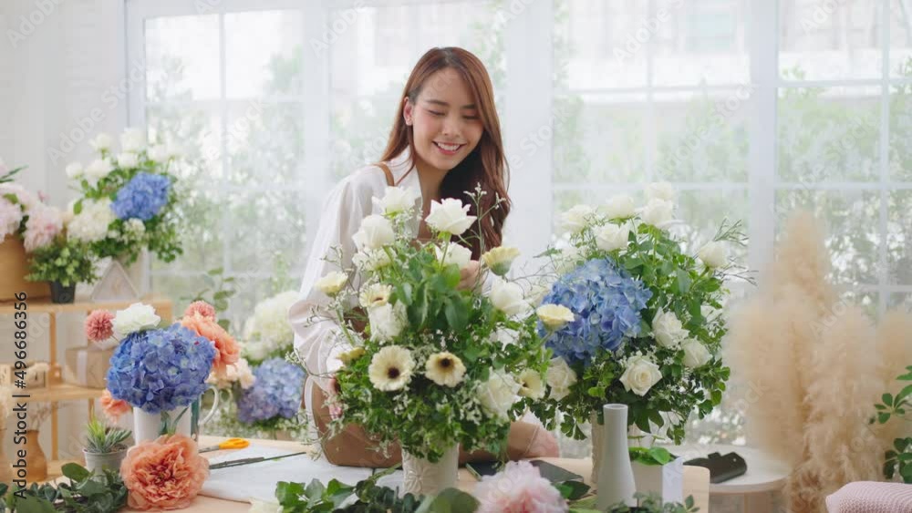 Small business and New market concept.Young florist female making bouquet of roses at workplace.woman artist working in flower shop studio.Floristry showing masterclass on creating flower arrangement. Small business and New market concept.Young florist female making bouquet of roses at workplace.woman artist working in flower shop studio.Floristry showing masterclass on creating flower arrangement.