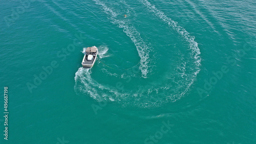 Aerial photo of extreme power boat water-sports cruising in high speed in tropical emerald bay © aerial-drone