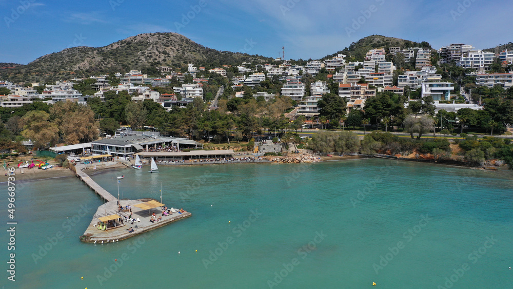 Obraz premium Aerial drone photo of famous celebrity sandy beach of Astir or Asteras in south Athens riviera with turquoise clear sea, Vouliagmeni, Greece