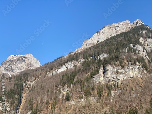 Rocky peaks Mättlistock (or Maettlistock) and Dejenstogg (or Dejenstock) in Glarus Alps mountain range, over the Klöntalersee reservoir lake and Klöntal alpine valley - Canton of Glarus, Switzerland