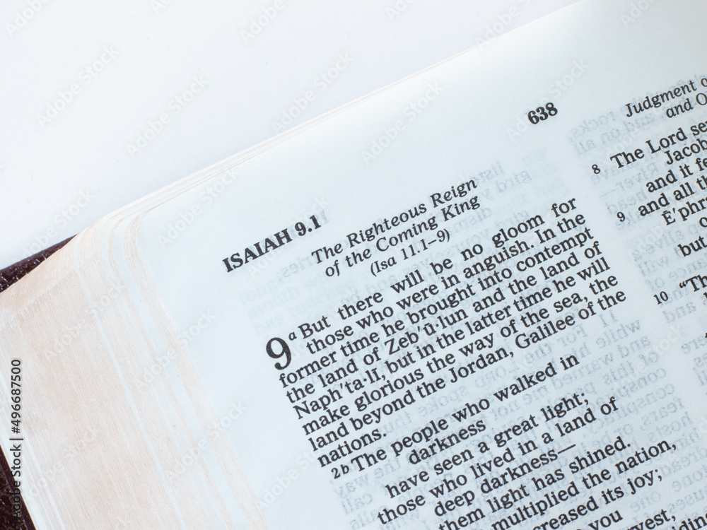 Open Holy Bible Book Isaiah 9 prophecy, the righteous reign of Jesus Christ second coming. The Christian biblical concept of hope, justice, love, and salvation from the LORD. A closeup. Open Holy Bible Book Isaiah 9 prophecy, the righteous reign of Jesus Christ second coming. The Christian biblical concept of hope, justice, love, and salvation from the LORD. A closeup.