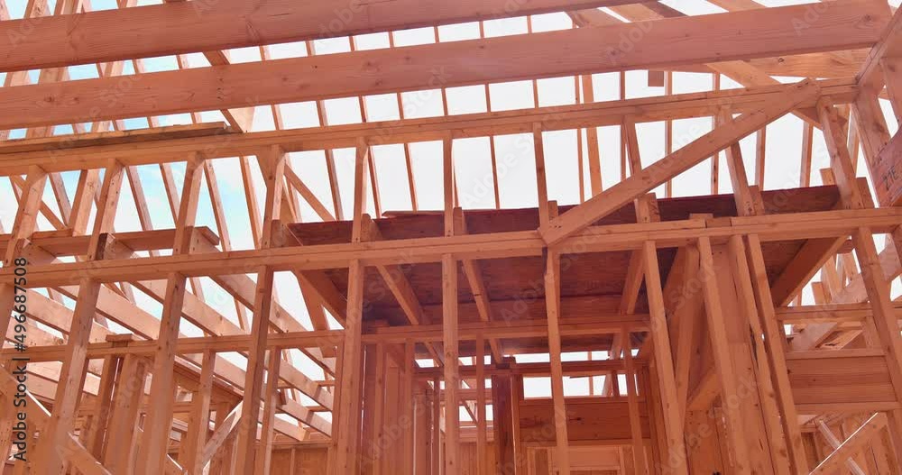 Installation of frame trusses joining with wooden beams at construction site Installation of frame trusses joining with wooden beams at construction site
