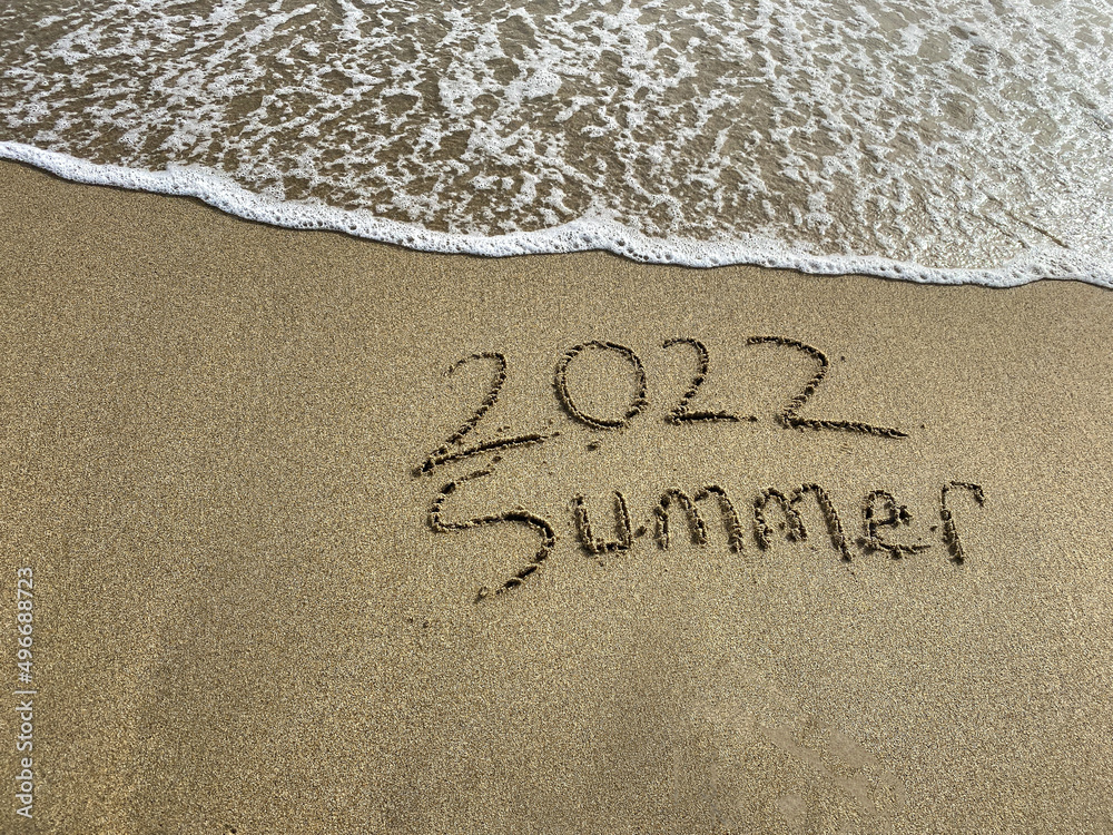 Fototapeta premium 2022 summer is coming , summer writing on the beach , sea water is coming