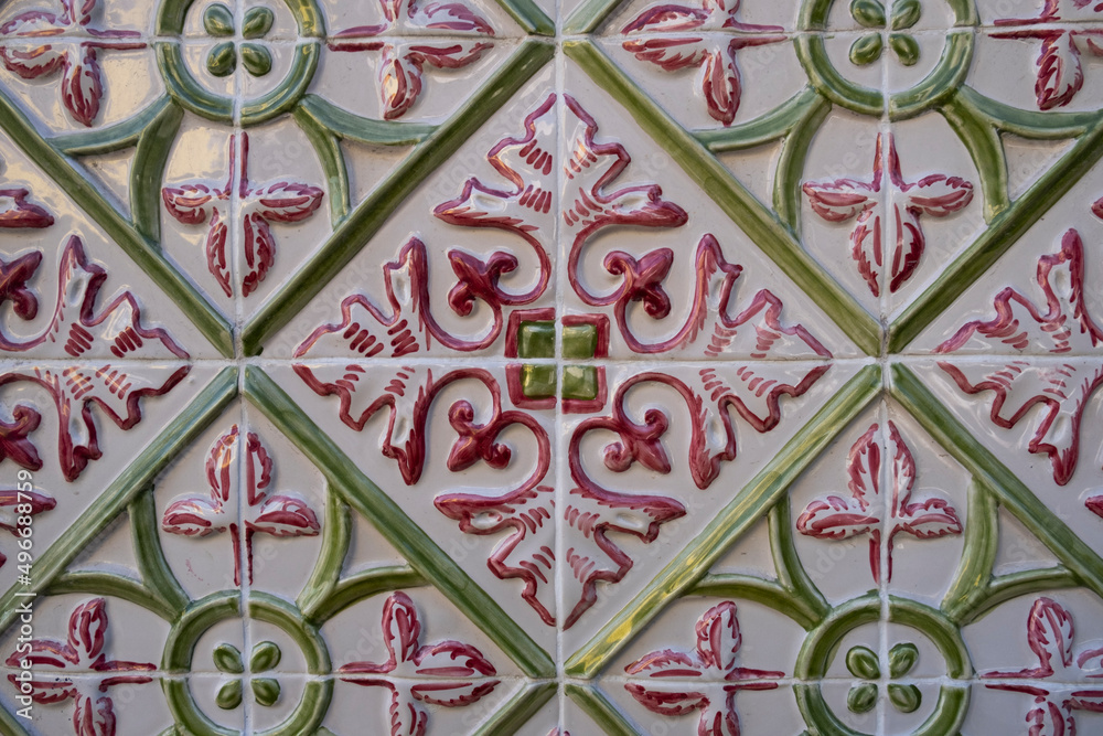 Red green tile pattern on the facade of the building