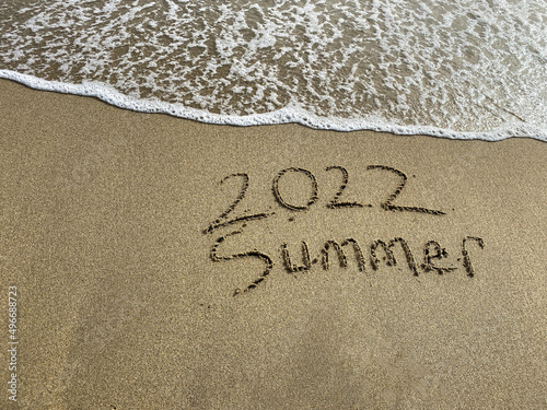 Sticker 2022 summer is coming , summer writing on the beach , sea water is coming