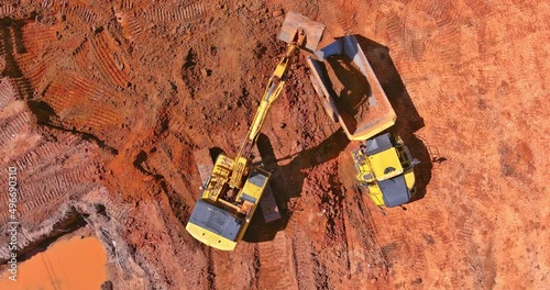 Preparing place to construction site for residential house on tractor bucket is filling a soil in truck