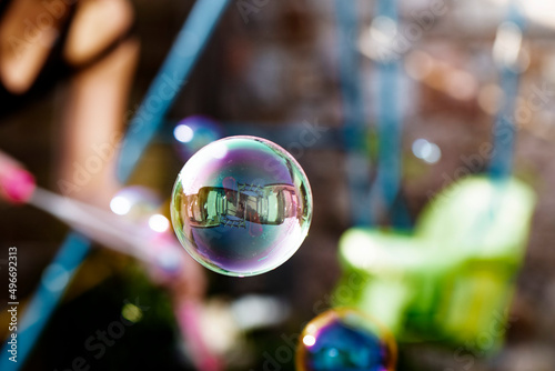 A bubble floating through a garden party