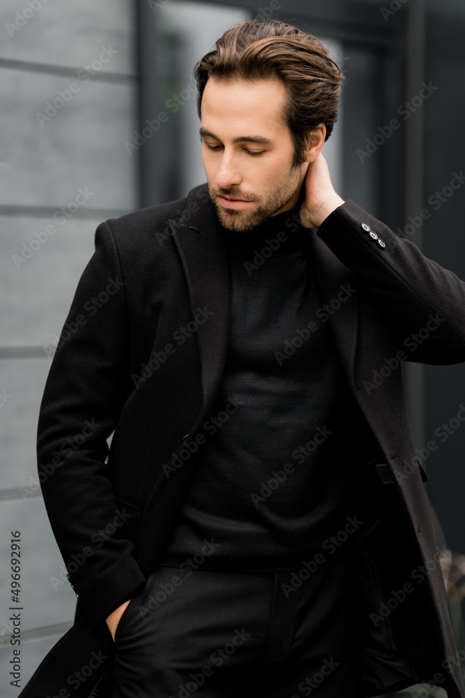 Portrait of confident beard caucasian man, looking directly at the camera, wearing formal classic suit. Handsome business man posing for the photo in stylish cloth, fashion concept