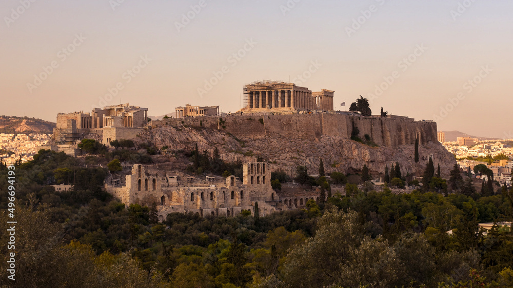 The Acropolis of Athens, Greece, with the Parthenon Temple atop the hill during sunset.