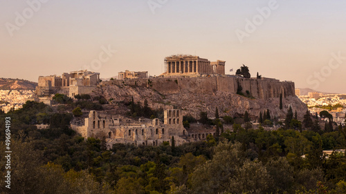 The Acropolis of Athens, Greece, with the Parthenon Temple atop the hill during sunset.