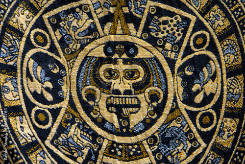 stone of the sun or Aztec calendar or solar calendar embodied in a Mexican textile or handicraft