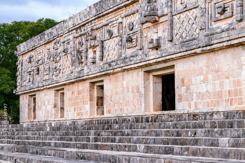 Nunnery Quadrangle structure with stone carvings on the wall at Uxmal, famous archaeological site, representative of the Puuc architectural style, in Yucatan, Mexico