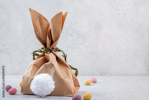 Easter bunny gift bag. Happy Easter holiday background concept. Flat lay minimalism paper bag same bunny or rabbit for gift