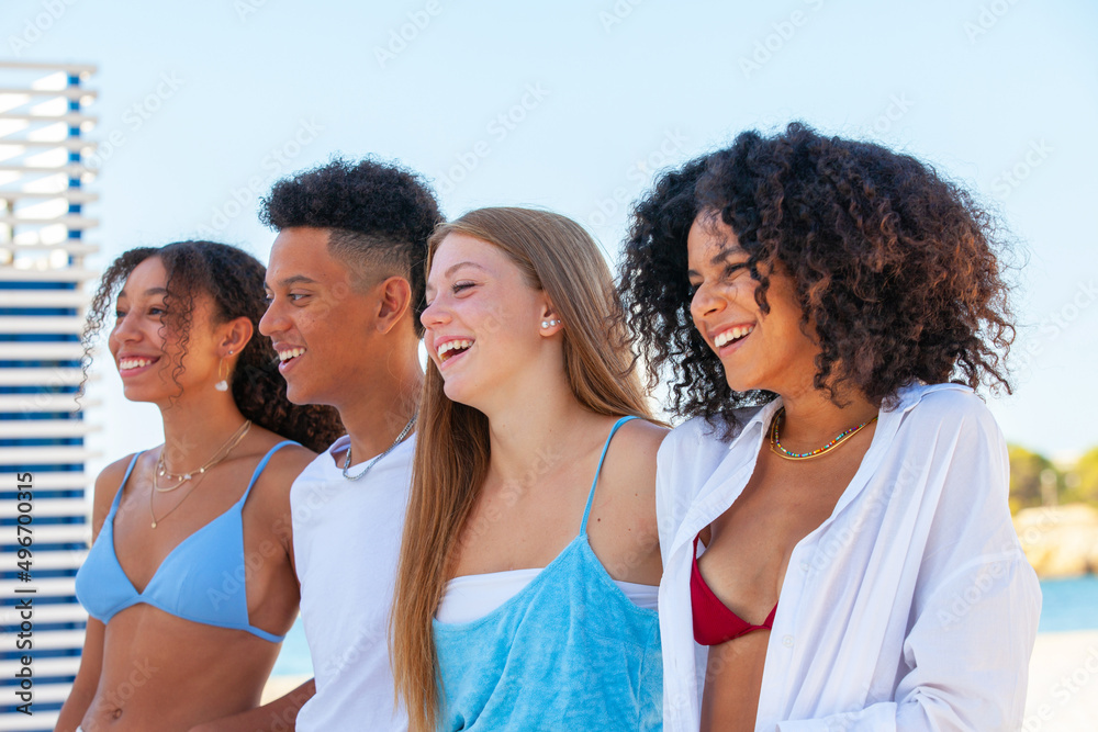 happy diverse group of friends at beach