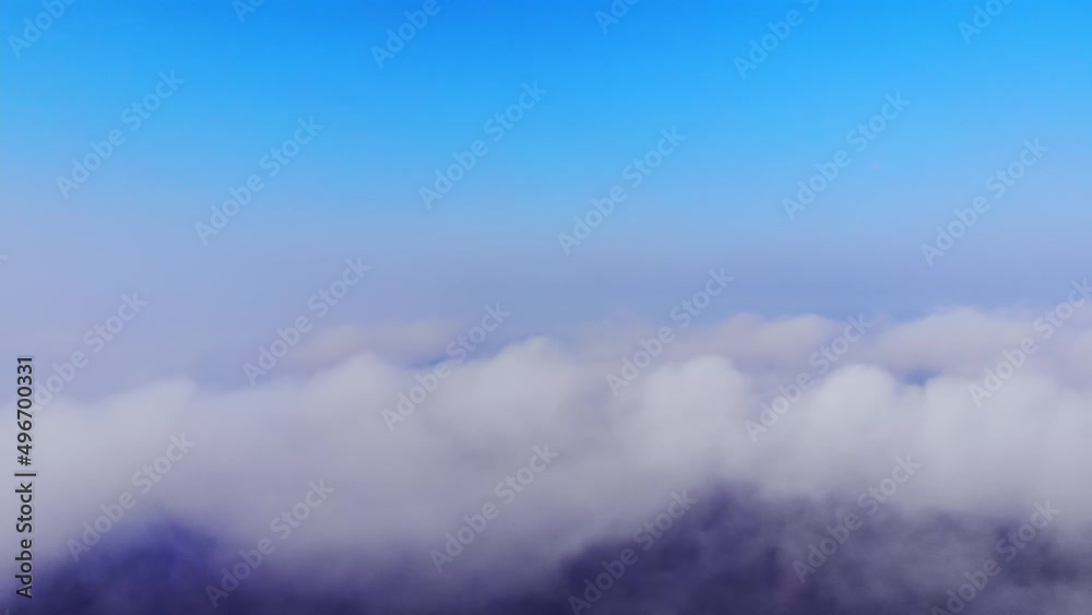 Aerial panorama over heavy cloud fog in city centre with buildings at sunrise Aerial panorama over heavy cloud fog in city centre with buildings at sunrise