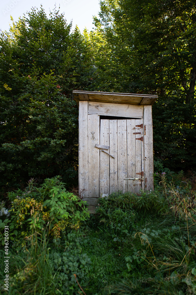 Wooden toilet in a forest grove. Toilet outside in rustic style. Wooden toilet in a forest grove. Toilet outside in rustic style.