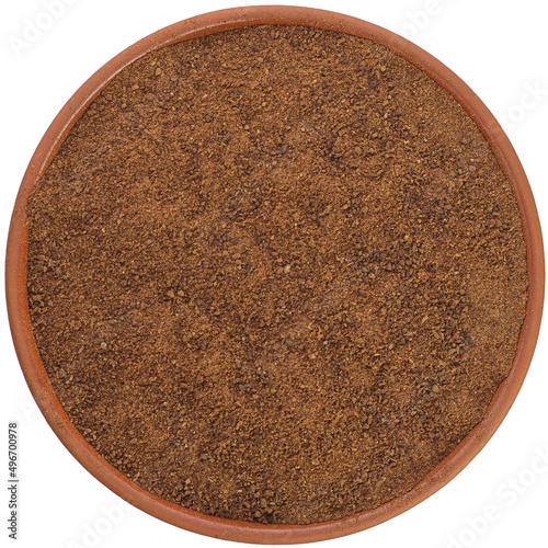 Clove ground in a brown ceramic bowl isolated on white background. Isolated close-up photo of food close up from above on white background.