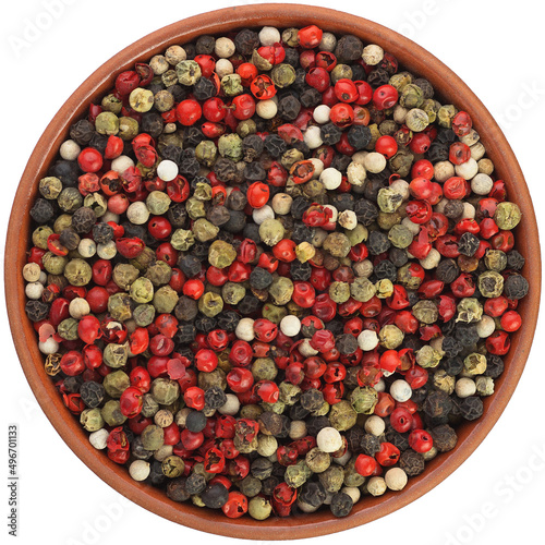 Four Pepper Blend peppercorns in a brown ceramic bowl isolated on white background. Isolated close-up photo of food close up from above on white background.