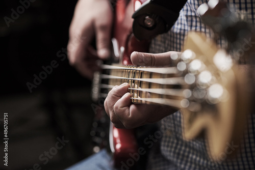 I am my own rockstar. Cropped shot of an unrecognizable man playing an electric guitar at home.
