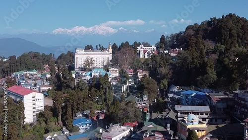 Slow Drone shot of Darjeeling and Kangchenjunga mountain range in background, sunny morning in hills, slow reveal shot photo