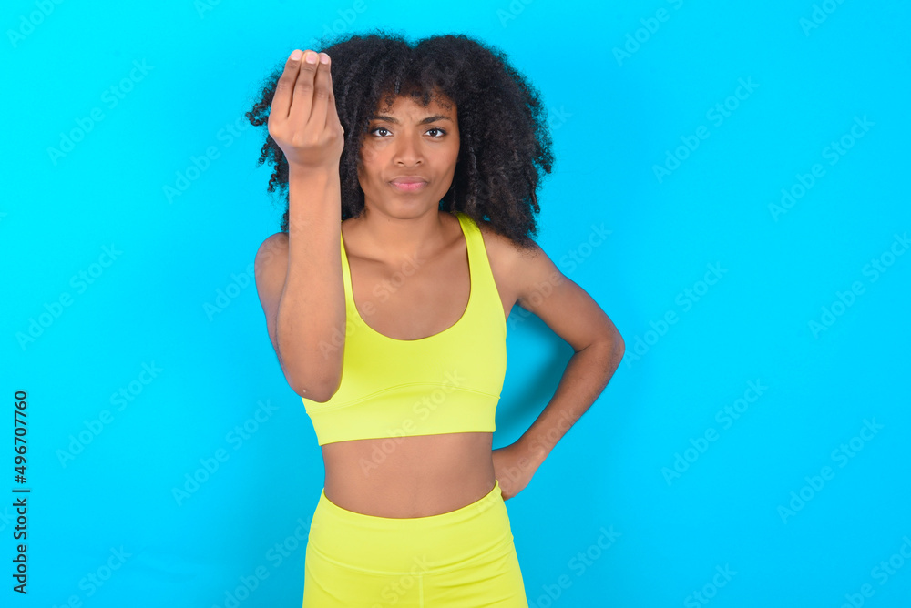 What the hell are you talking about. Shot of frustrated young woman with afro hairstyle gesturing with raised hand doing Italian gesture, frowning, being displeased and confused with dumb question. What the hell are you talking about. Shot of frustrated young woman with afro hairstyle gesturing with raised hand doing Italian gesture, frowning, being displeased and confused with dumb question.